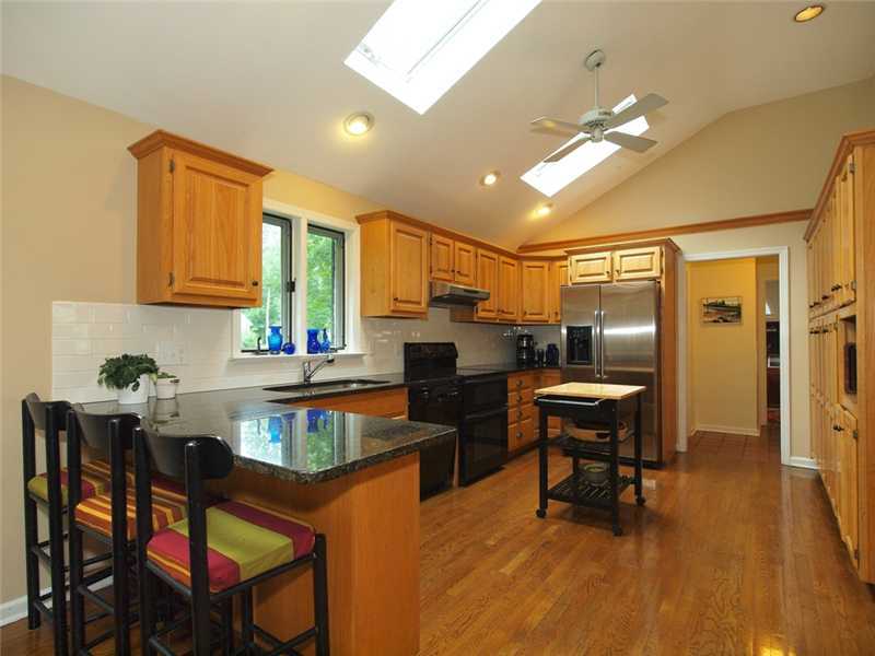 2 Shady Acres Road Darien, CT 06820 - Photo 7 of 18 a kitchen with a table chairs refrigerator and cabinets