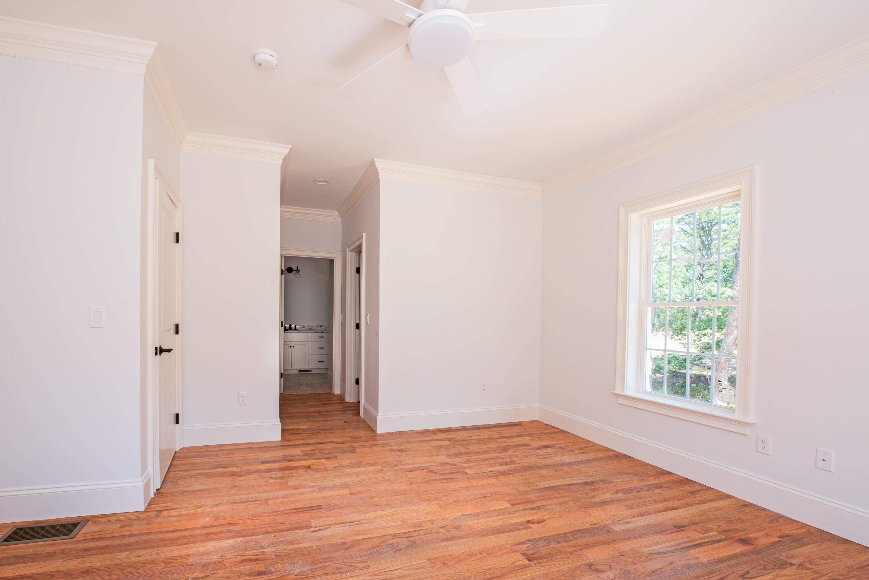 36 Sam Hollow Road Wellfleet, MA 02667 - Photo 15 of 43 a view of an empty room with wooden floor and a window