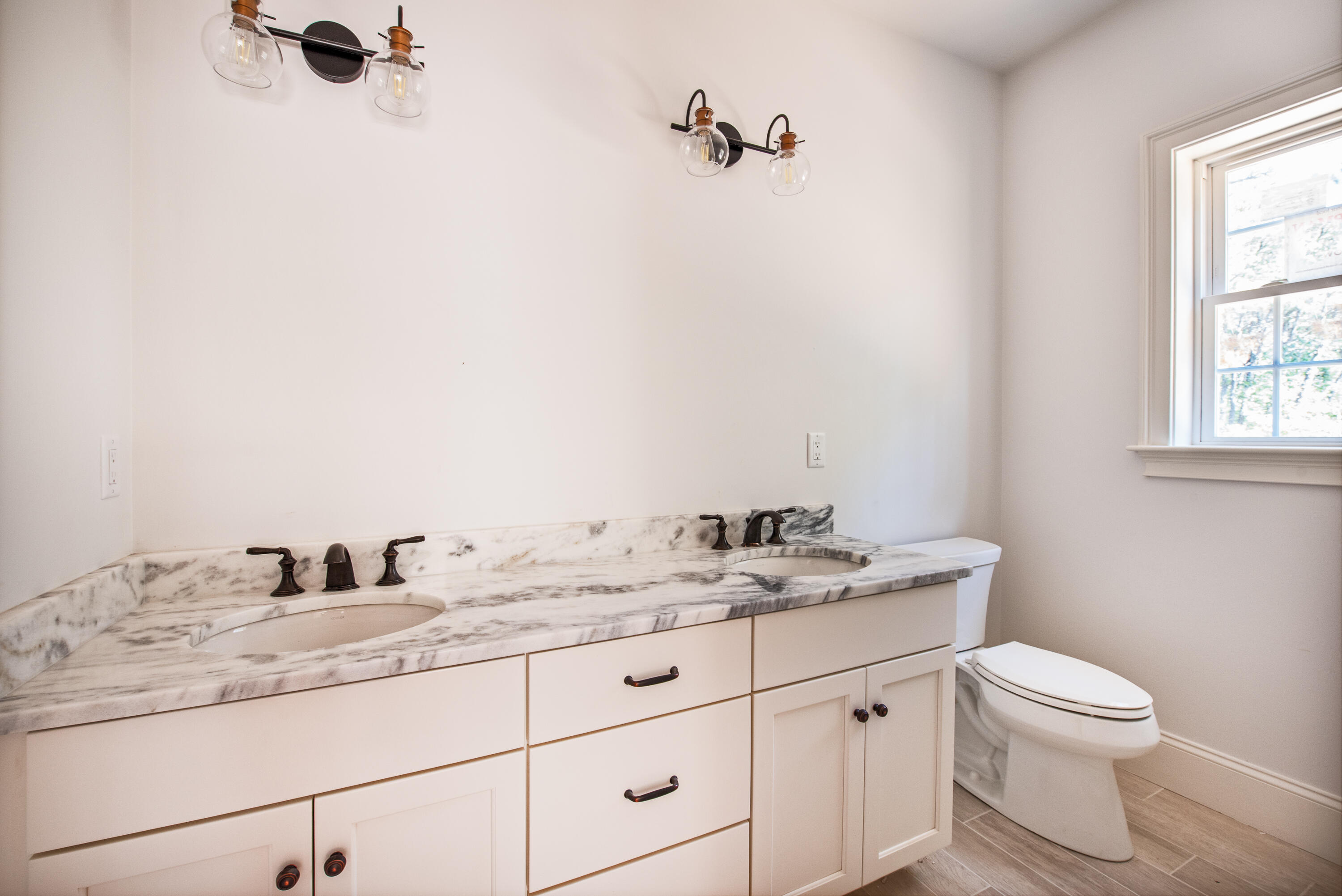 36 Sam Hollow Road Wellfleet, MA 02667 - Photo 17 of 43 a bathroom with a granite countertop sink vanity mirror and toilet
