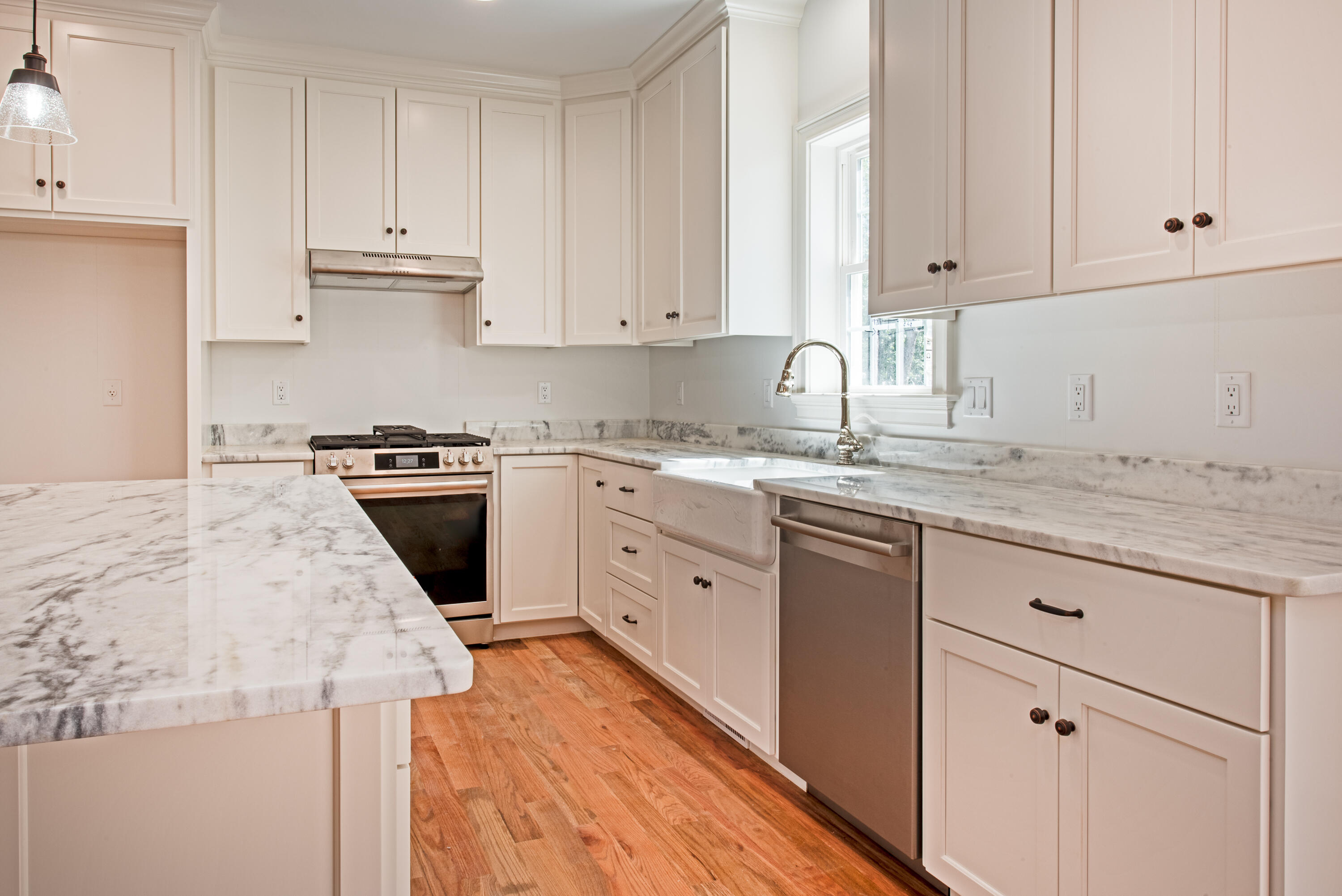 36 Sam Hollow Road Wellfleet, MA 02667 - Photo 3 of 43 a kitchen with granite countertop white cabinets sink and stainless steel appliances
