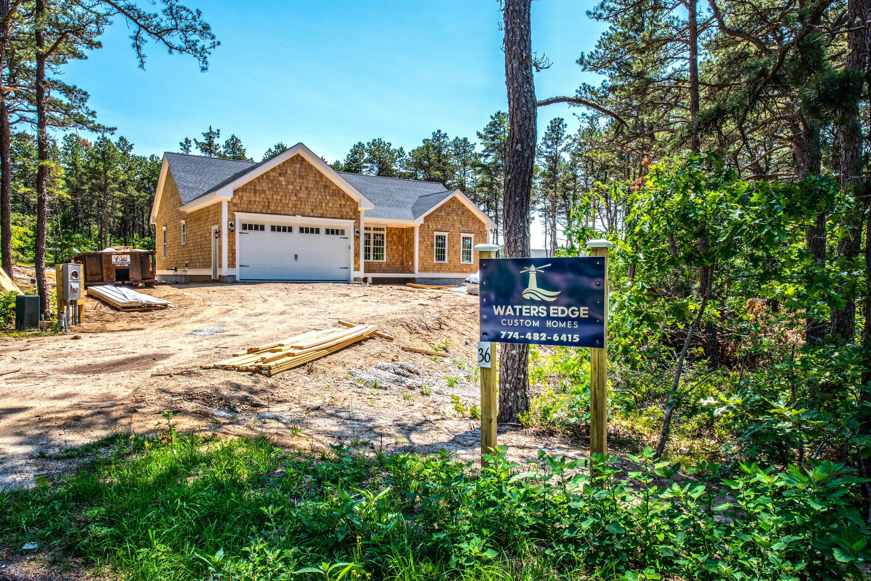 36 Sam Hollow Road Wellfleet, MA 02667 - Photo 31 of 43 a front view of a house with a yard and garage