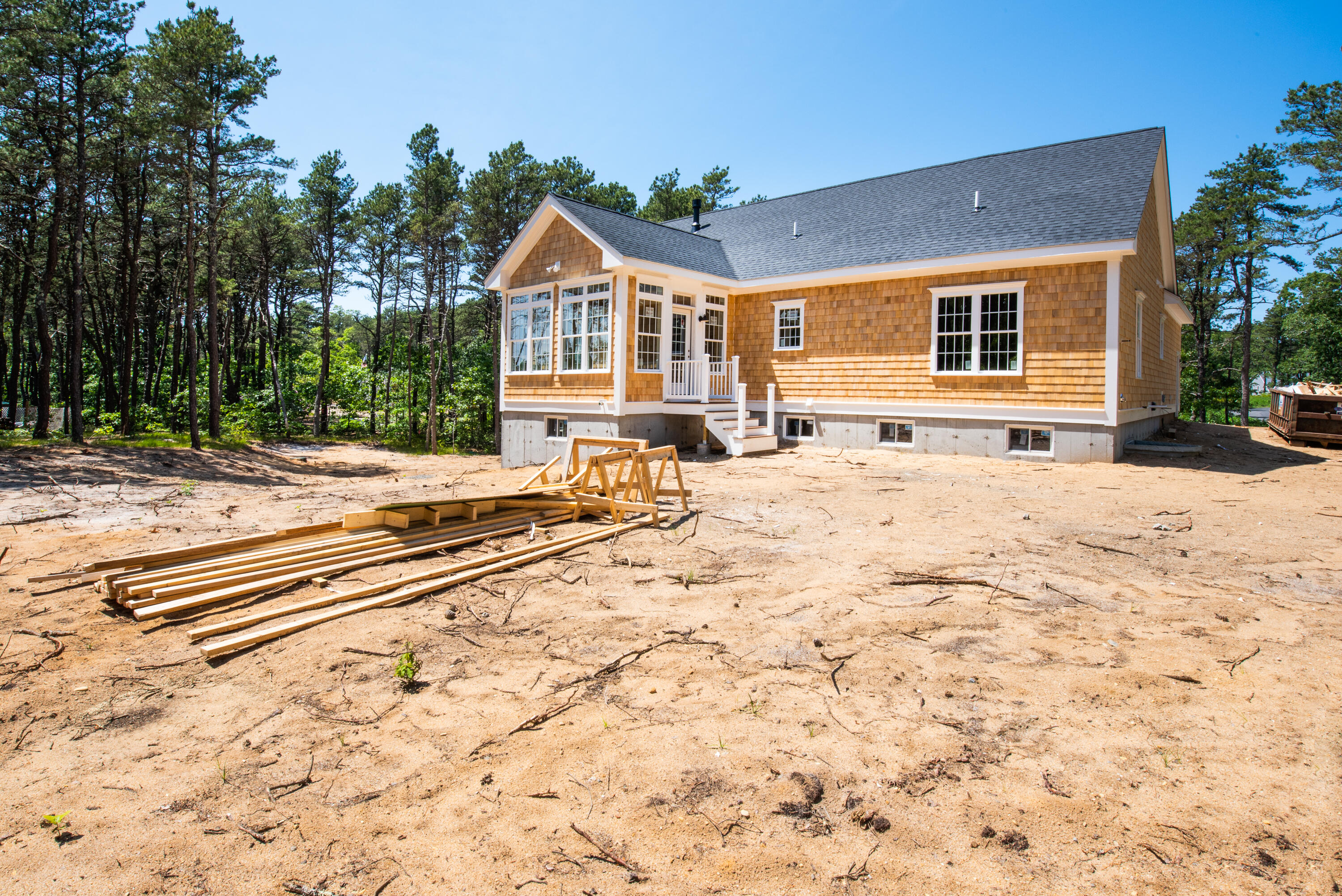 36 Sam Hollow Road Wellfleet, MA 02667 - Photo 32 of 43 a front view of a house with a yard
