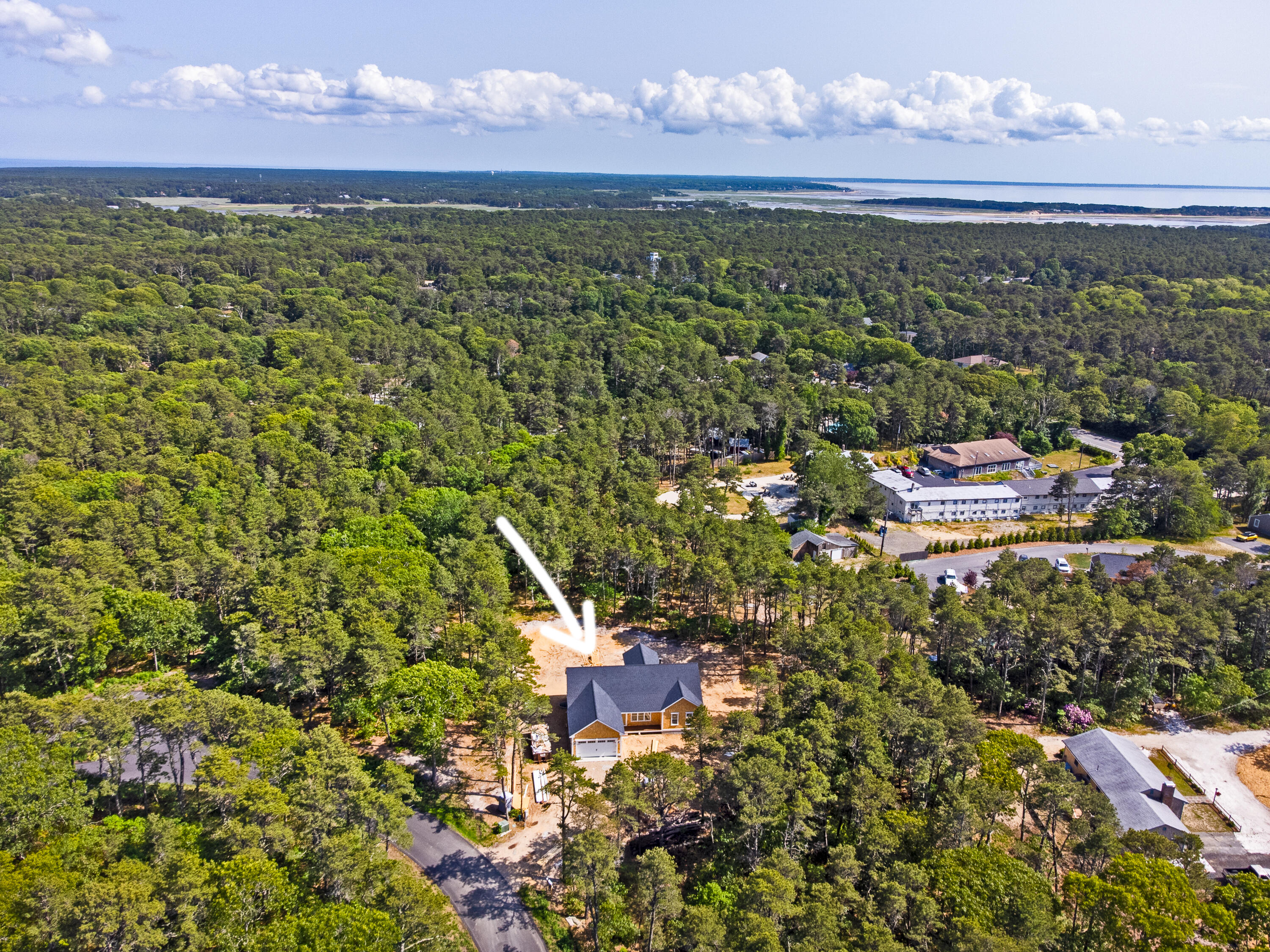 36 Sam Hollow Road Wellfleet, MA 02667 - Photo 41 of 43 a view of a lake with a building in the background