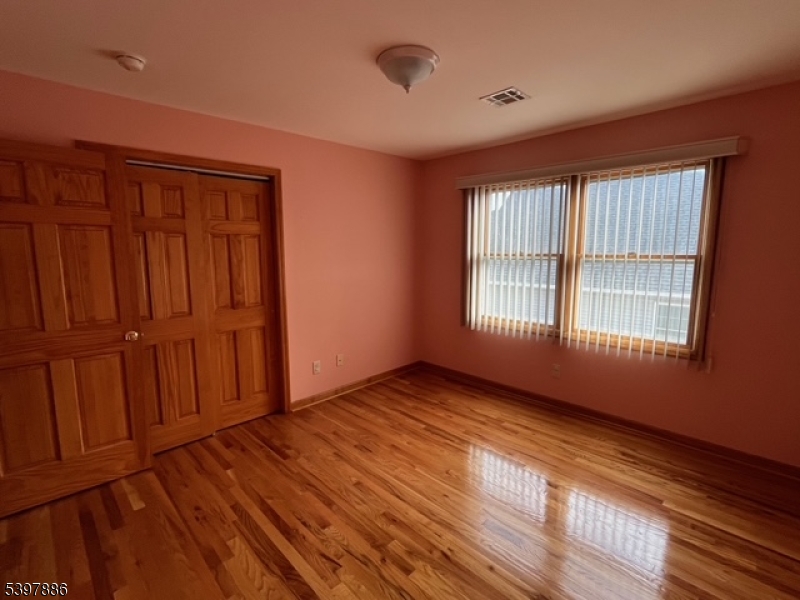 502 Summit Avenue, Unit 1 Westfield, NJ 07090 - Photo 12 of 19 a view of an empty room with wooden floor and a window