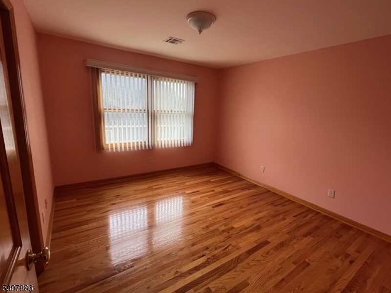 502 Summit Avenue, Unit 1 Westfield, NJ 07090 - Photo 13 of 19 a view of an empty room with wooden floor and a window