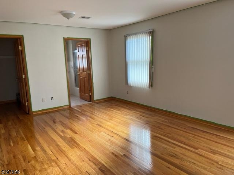 502 Summit Avenue, Unit 1 Westfield, NJ 07090 - Photo 17 of 19 a view of empty room with wooden floor and fan