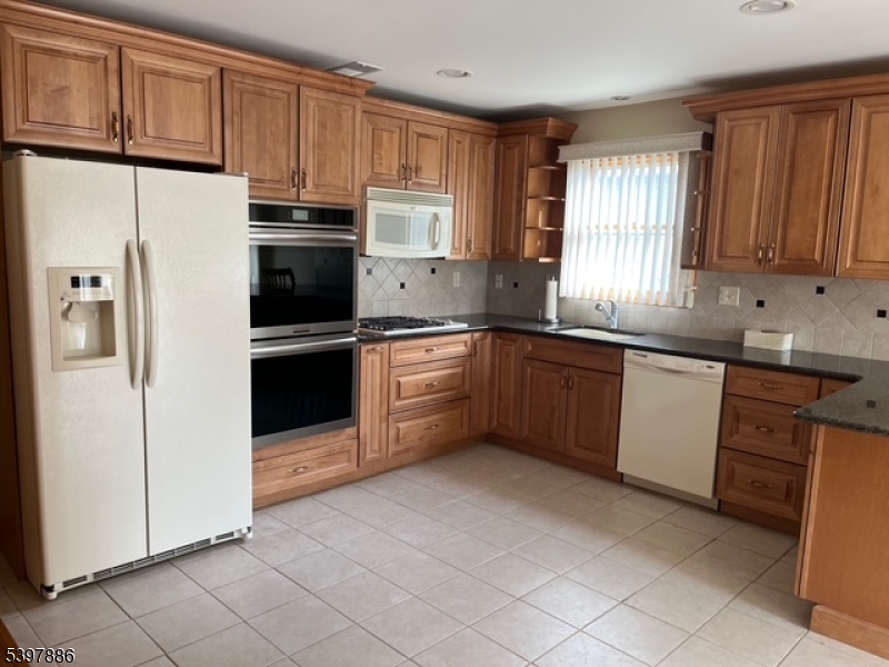 502 Summit Avenue, Unit 1 Westfield, NJ 07090 - Photo 4 of 19 a kitchen with stainless steel appliances granite countertop a refrigerator sink and cabinets