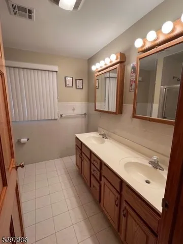 a bathroom with a sink a mirror and a bathtub