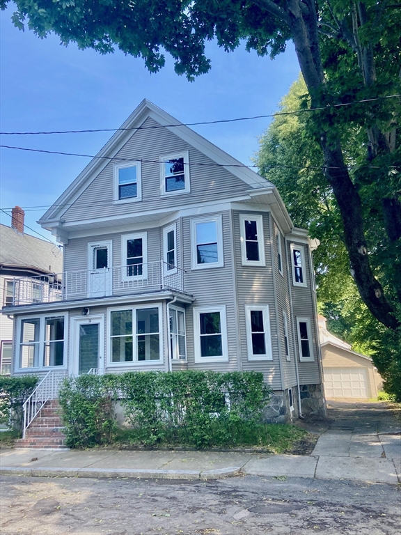 14 Welton Road Boston, MA 02132 - Photo 1 of 31 a front view of a house with a garden
