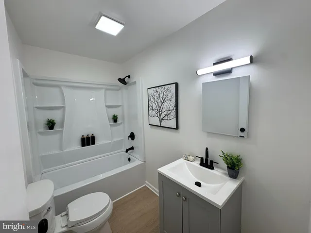 a bathroom with a toilet a sink and a bathtub