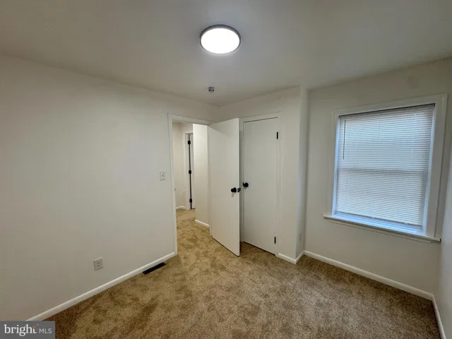 an empty room with windows and window