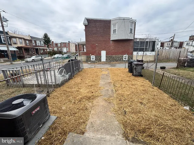 a view of a building with snow on the road
