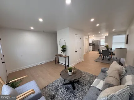 a living room with furniture and kitchen view