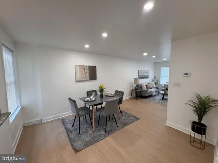 a dining room with furniture and wooden floor