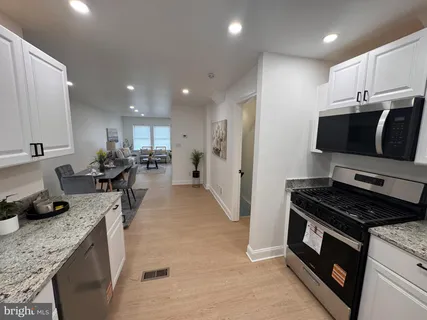 a kitchen with a sink stove and refrigerator