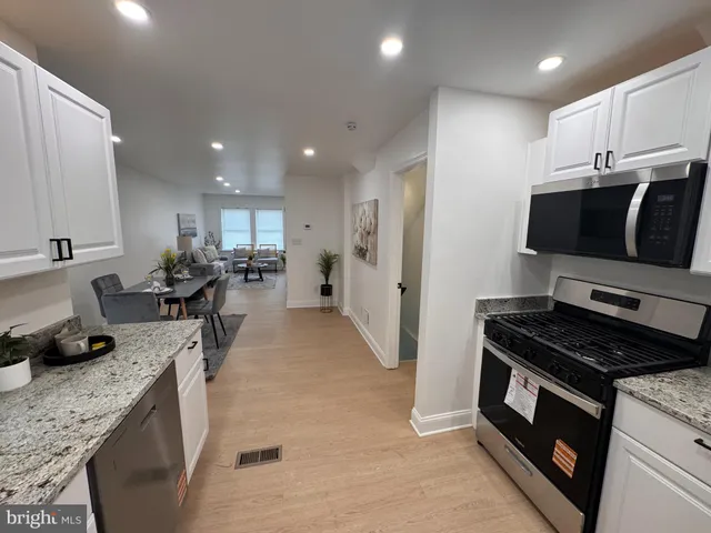 a kitchen with a sink stove and refrigerator