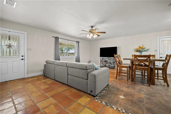a living room with furniture and a flat screen tv