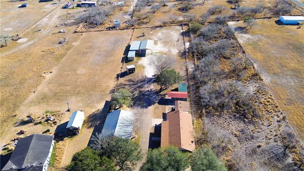 an aerial view of a house with a yard