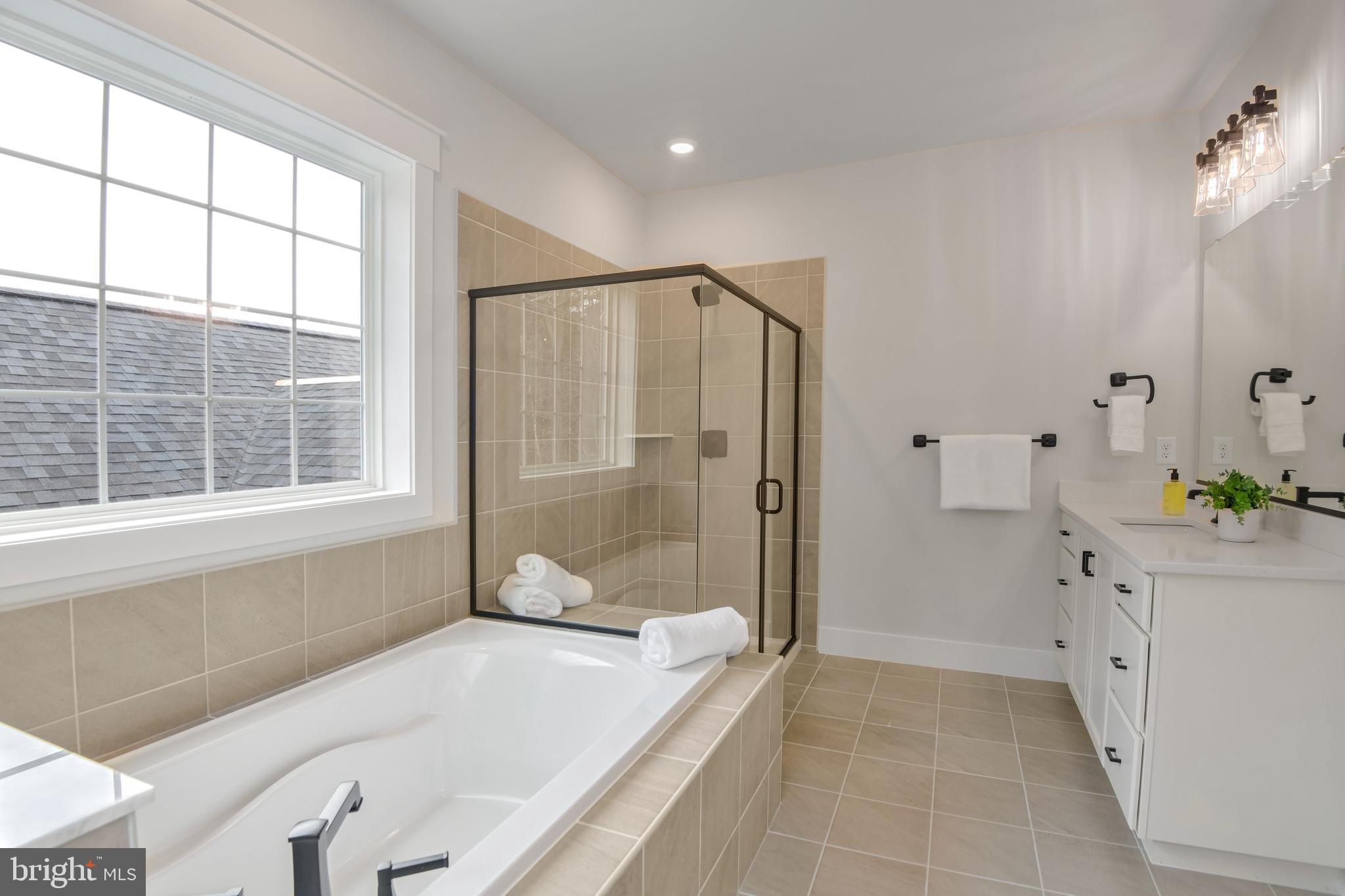 Eliana Court Laurel, MD 20708 - Photo 25 of 46 a bathroom with a bathtub and a sink