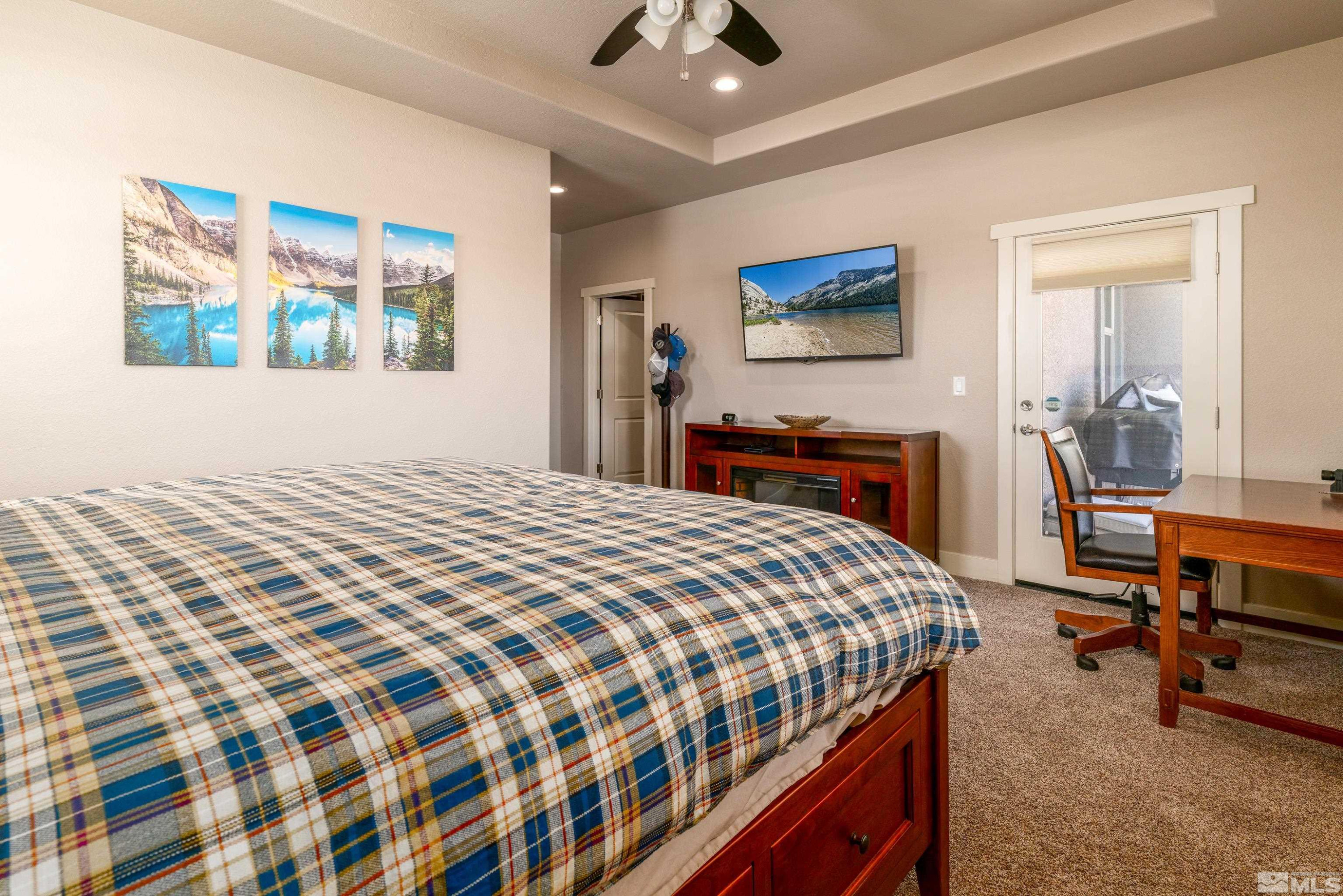 1230 West Cottage Loop Gardnerville, NV 89460 - Photo 11 of 25 a bedroom with a bed and a chandelier