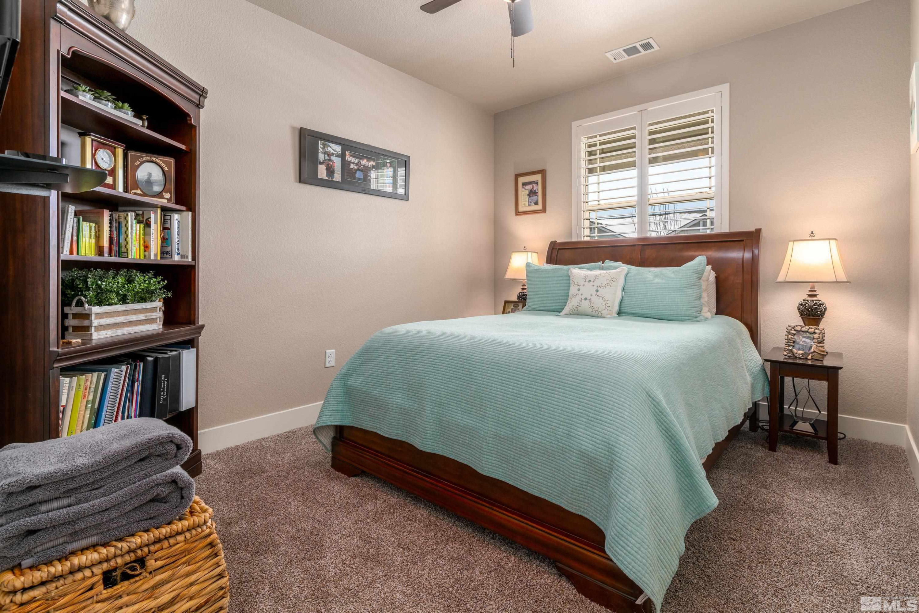 1230 West Cottage Loop Gardnerville, NV 89460 - Photo 16 of 25 a bedroom with a bed furniture and a book shelf