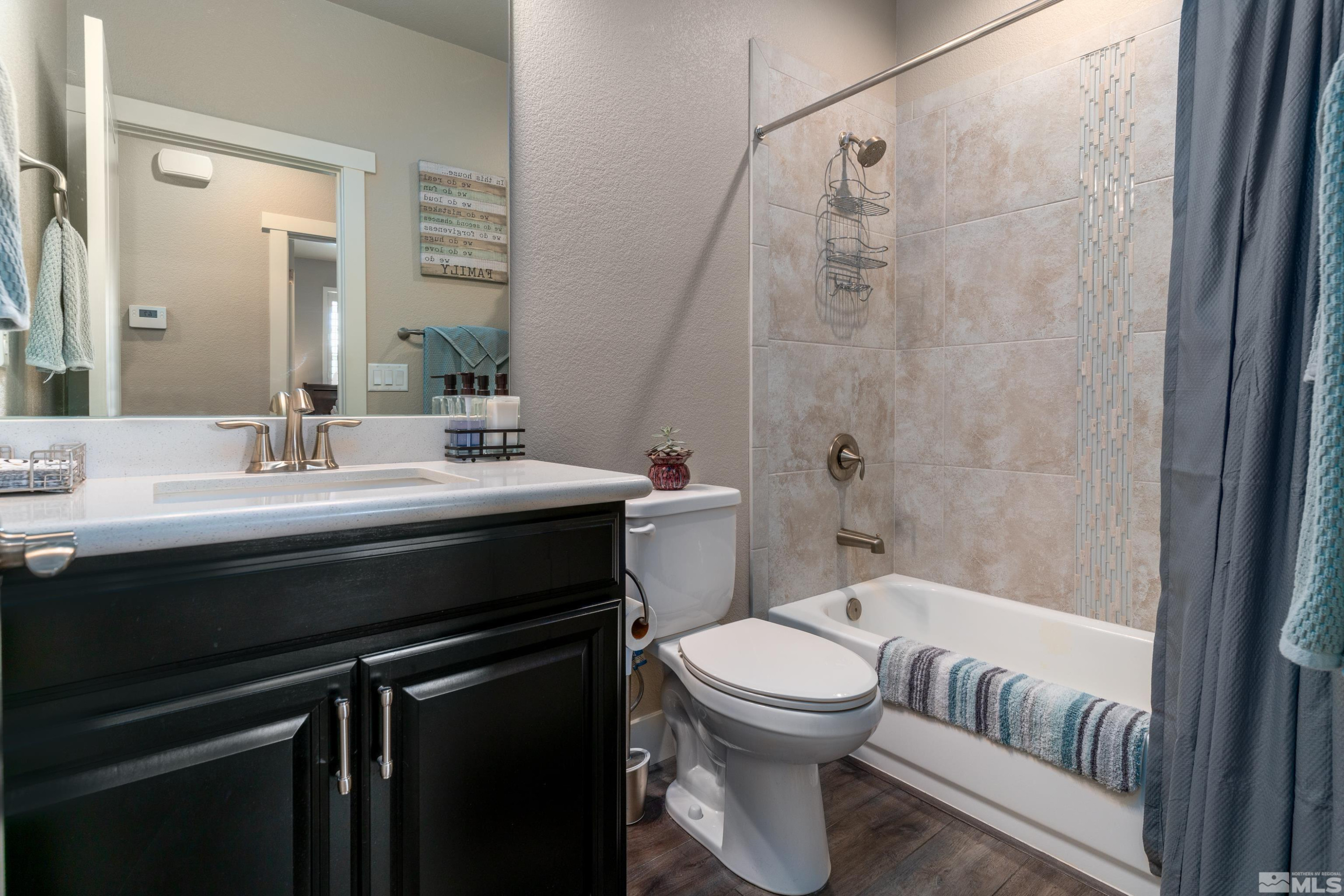 1230 West Cottage Loop Gardnerville, NV 89460 - Photo 17 of 25 a bathroom with a sink a toilet and shower