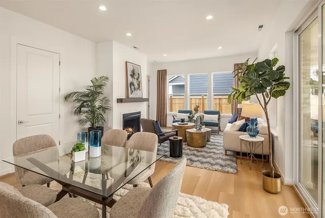 a living room with furniture a fireplace and a potted plant