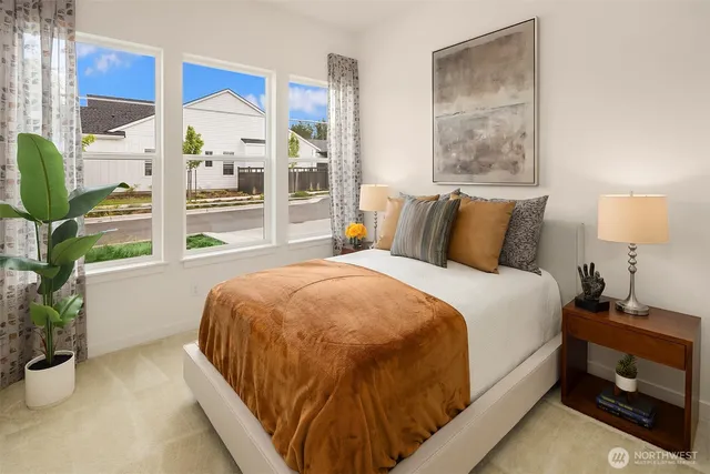 a bed sitting in a bedroom next to a window