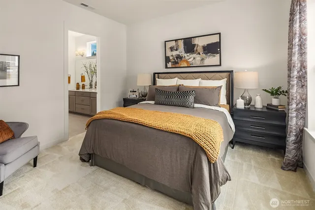 a bedroom with a bed and a painting on the wall