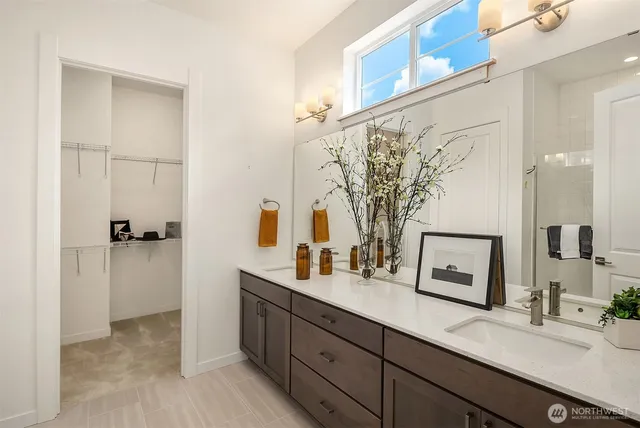 a bathroom with a double vanity sink mirror and
