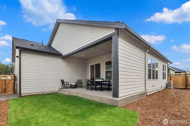 a view of a backyard with furniture and a garage