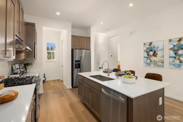 a kitchen with refrigerator and stove