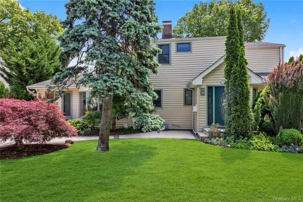a view of a house with a yard and garden