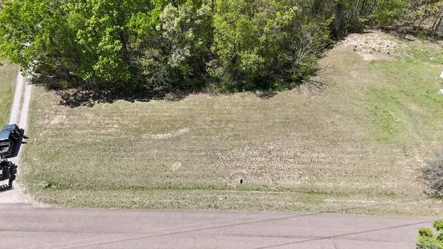 a view of a yard with wooden fence