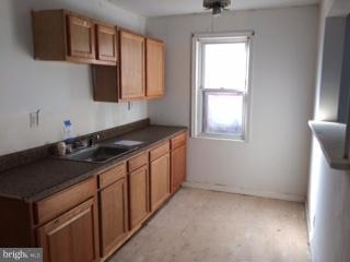 625 Delaware Avenue Baltimore, MD 21221 - Photo 3 of 6 a kitchen with stainless steel appliances granite countertop a sink stove and microwave