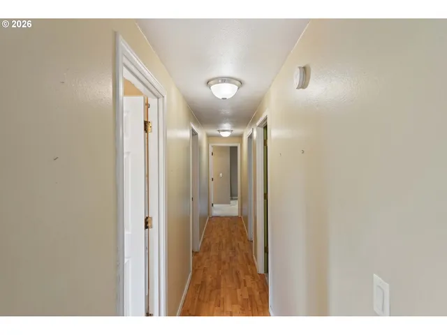 a view of empty room with window and fireplace