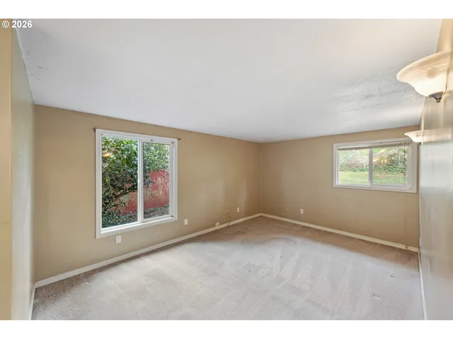 a view of an empty room and a window