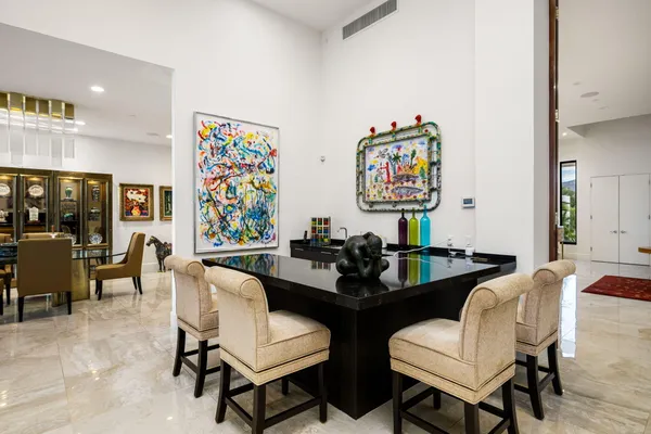 a spacious bedroom with a bed a couch and a large window