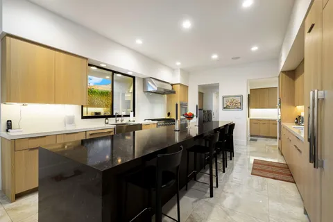 a view of a patio with a dining table and chairs with wooden floor