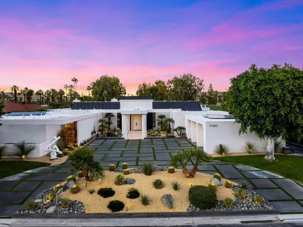 a living room with furniture a fireplace and gym equipment