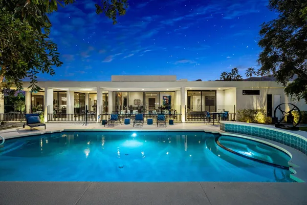 a living room filled with furniture and a flat screen tv