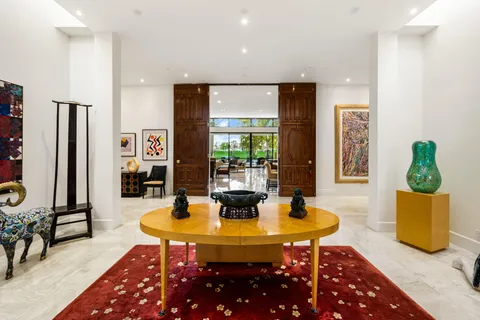 a bedroom with a bed and a flat tv screen on dresser