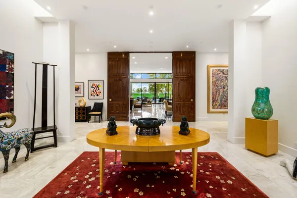a bedroom with a bed and a flat tv screen on dresser