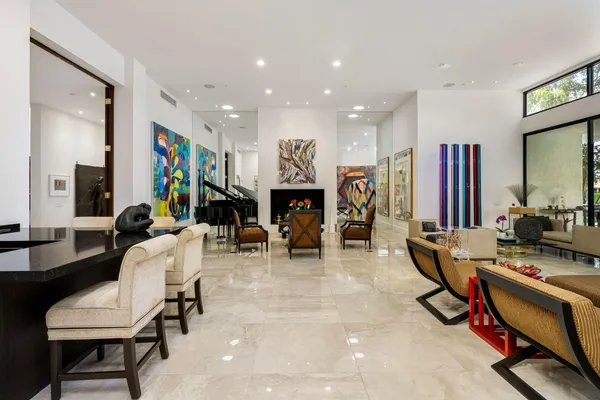 a work room with furniture a flat screen tv and a fireplace