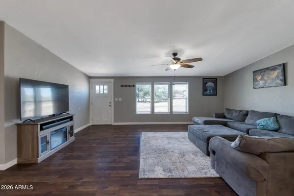 a living room with furniture and a flat screen tv