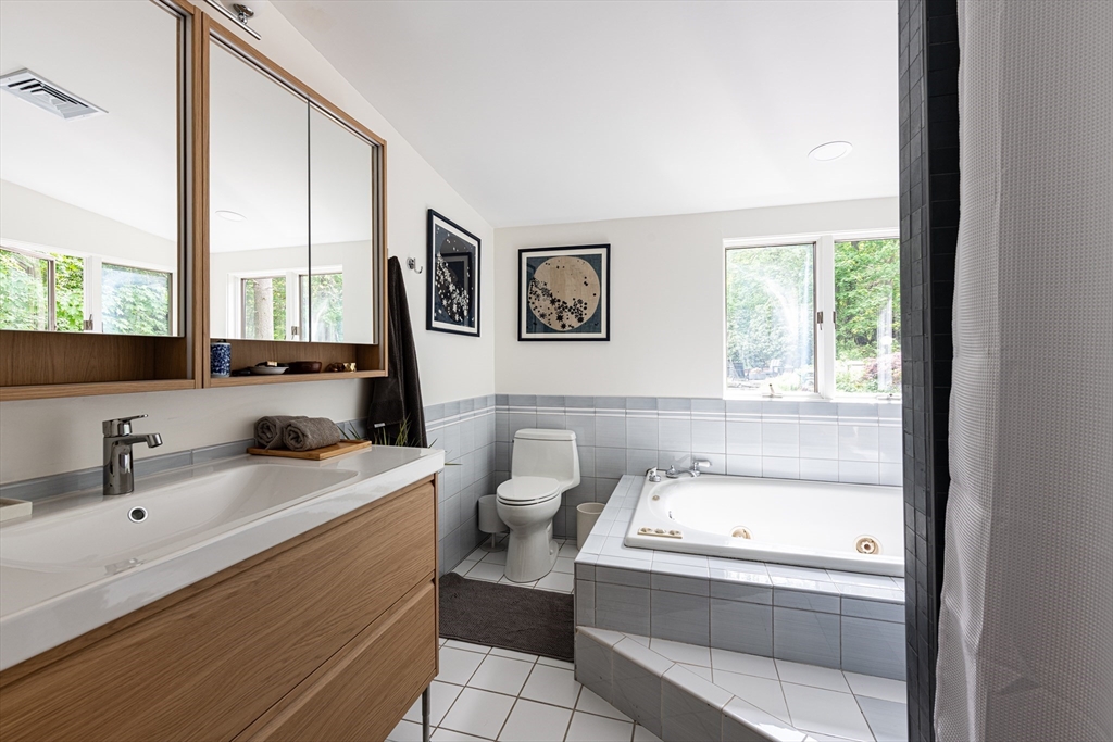 7 Diamond Road Lexington, MA 02420 - Photo 23 of 42 a bathroom with a tub sink and mirror