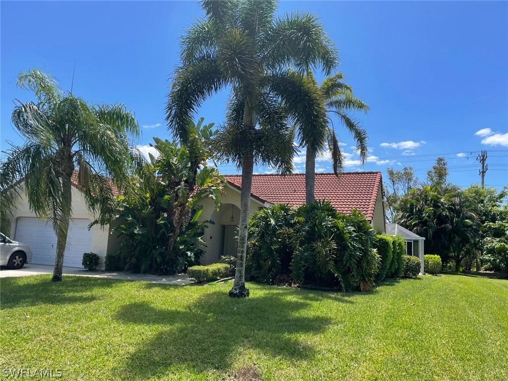 690 Morning Mist Lane Lehigh Acres, FL 33974 - Photo 1 of 20 a view of a backyard with a garden