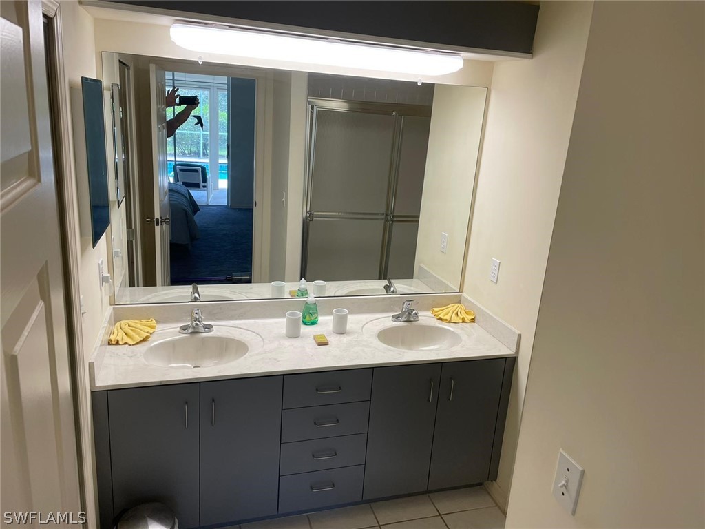 690 Morning Mist Lane Lehigh Acres, FL 33974 - Photo 11 of 20 a bathroom with a double vanity sink and a mirror