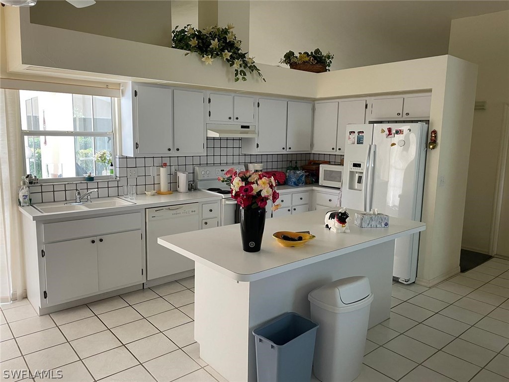 690 Morning Mist Lane Lehigh Acres, FL 33974 - Photo 12 of 20 a kitchen with a sink appliances and cabinets