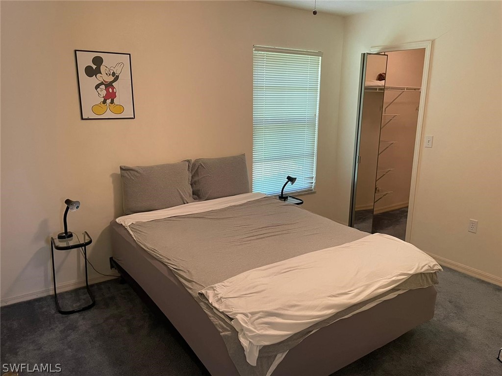 690 Morning Mist Lane Lehigh Acres, FL 33974 - Photo 14 of 20 a bedroom with a bed and wooden floor